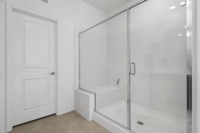 bathroom featuring tile patterned floors and a shower with door