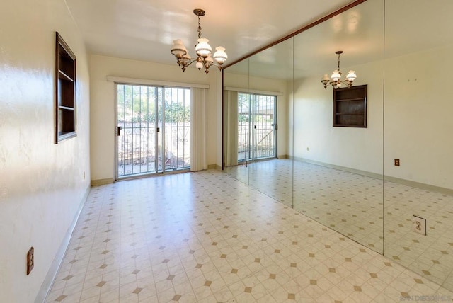 spare room with an inviting chandelier