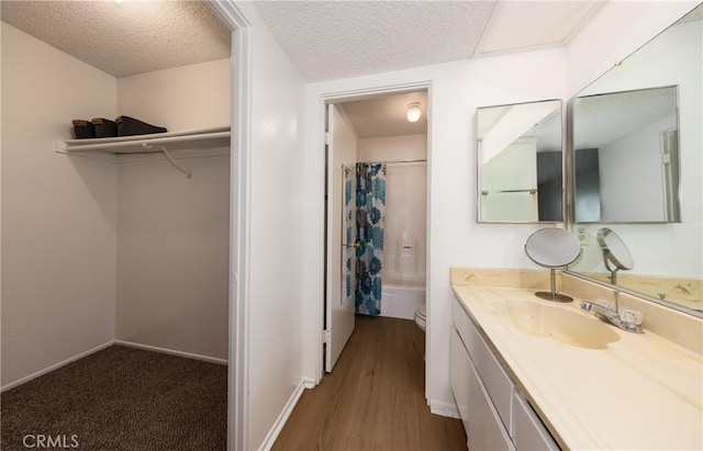 35172 Mesa Grande Dr, Calimesa, CA 92320 - bathroom with vanity, toilet, a textured ceiling, wood finished floors, and baseboards