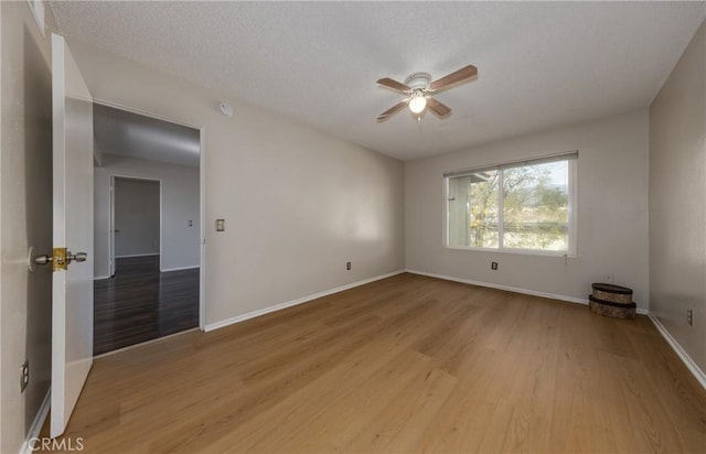 empty room featuring ceiling fan and light wood-type flooring