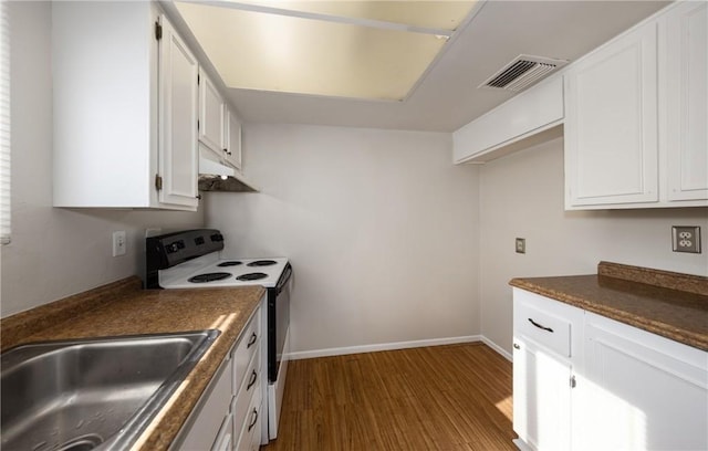 kitchen featuring wood-type flooring, sink, electric range oven, and white cabinets