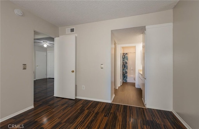 35172 Mesa Grande Dr, Calimesa, CA 92320 - unfurnished bedroom with dark wood-style floors, baseboards, and a textured ceiling