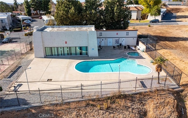 view of swimming pool with a patio and an in ground hot tub