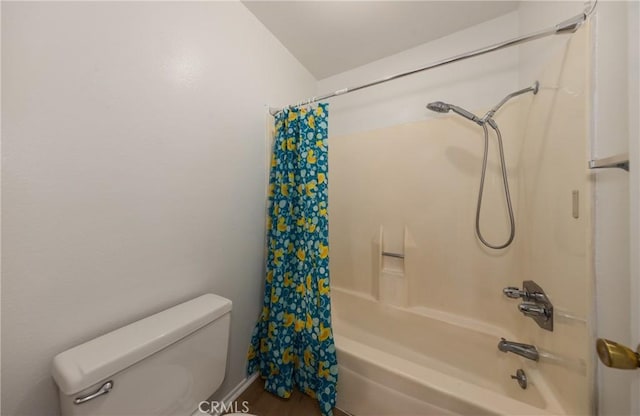 bathroom featuring toilet and shower / bath combo with shower curtain