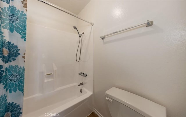 bathroom with shower / tub combo with curtain and toilet