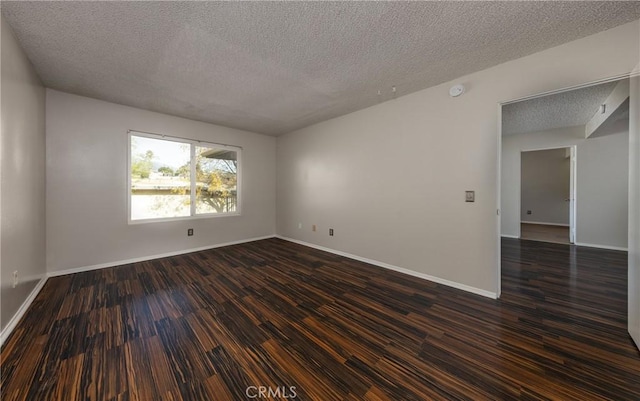 35172 Mesa Grande Dr, Calimesa, CA 92320 - empty room with a textured ceiling, dark wood-style floors, baseboards, and a smoke detector