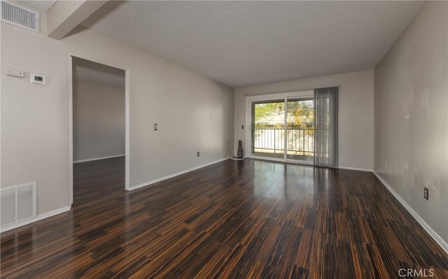 empty room with dark wood-type flooring