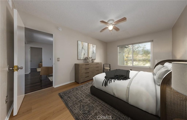 bedroom with ceiling fan and light wood-type flooring