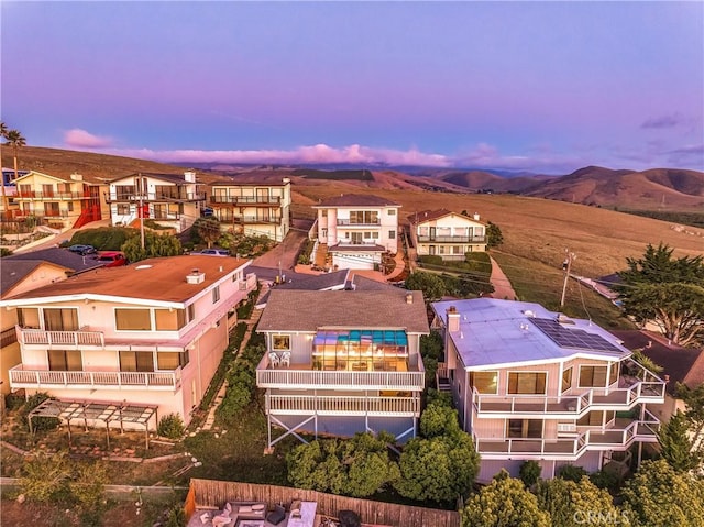 drone / aerial view featuring a residential view and a mountain view