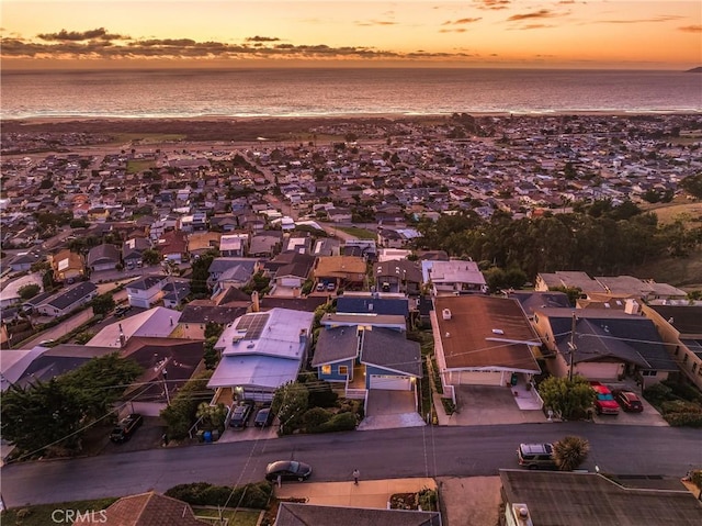 aerial view at dusk featuring a residential view