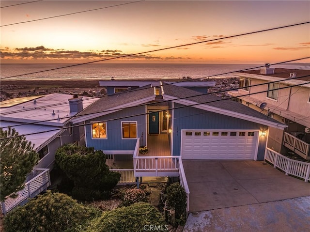 view of front of home featuring a garage and a water view