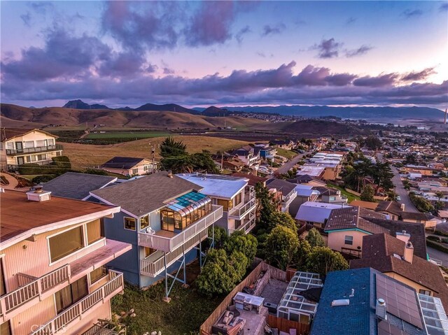 aerial view at dusk featuring a mountain view