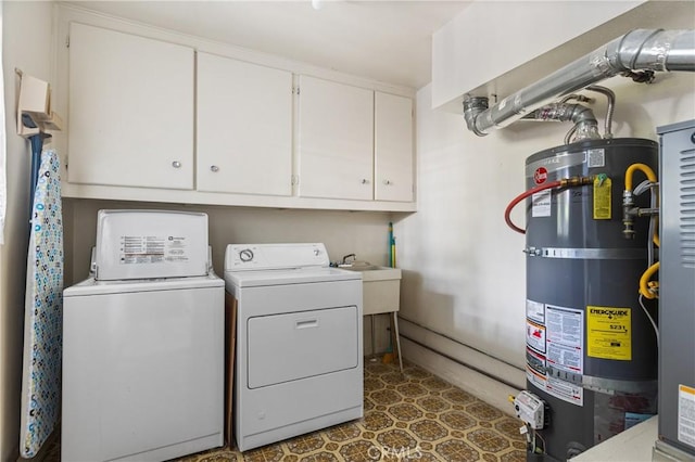 washroom featuring independent washer and dryer, cabinets, and water heater