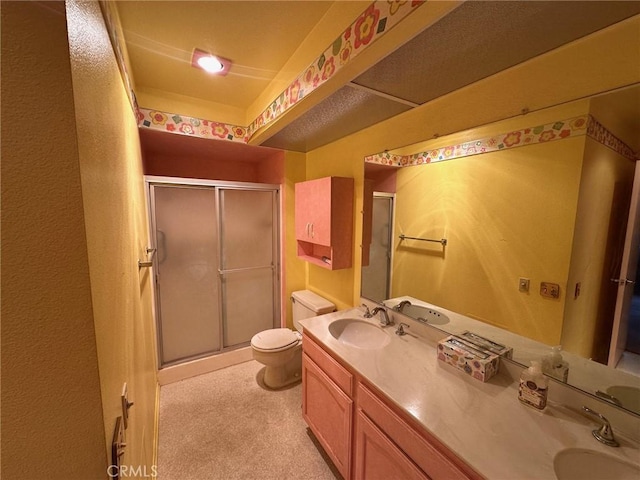 bathroom with vanity, toilet, and walk in shower