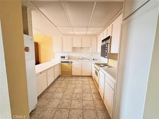 kitchen featuring sink, white appliances, and backsplash