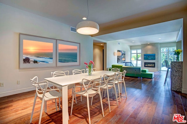 dining space with hardwood / wood-style flooring