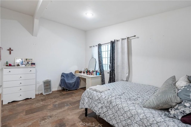 bedroom with dark hardwood / wood-style flooring and lofted ceiling with beams