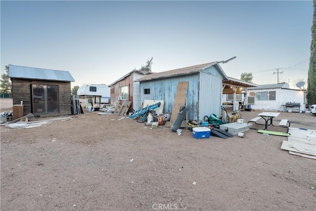 back of property with a shed