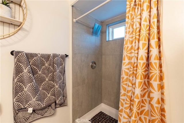 bathroom with a tile shower