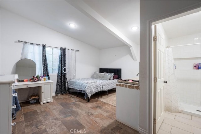 bedroom with vaulted ceiling and ensuite bathroom