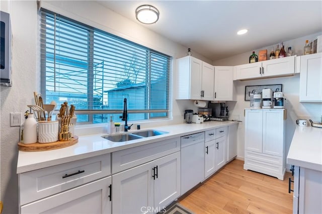 8079 White Rd, Phelan, CA 92371 - kitchen featuring white dishwasher, a sink, light countertops, white cabinets, and recessed lighting