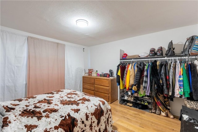 8079 White Rd, Phelan, CA 92371 - bedroom with wood finished floors and a textured ceiling