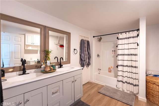 bathroom with shower / bathtub combination with curtain, vanity, and hardwood / wood-style flooring