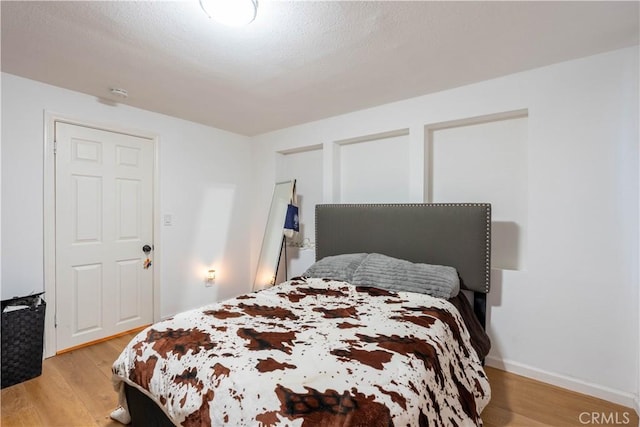 bedroom with light wood-type flooring