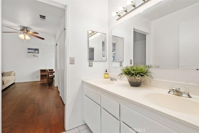 bathroom with ceiling fan, vanity, and wood-type flooring