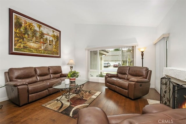 living room featuring lofted ceiling and dark hardwood / wood-style flooring