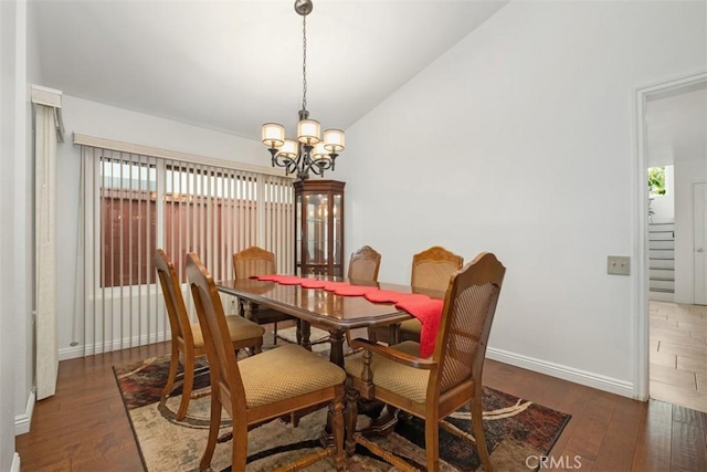 dining space featuring dark wood-type flooring, a healthy amount of sunlight, and lofted ceiling