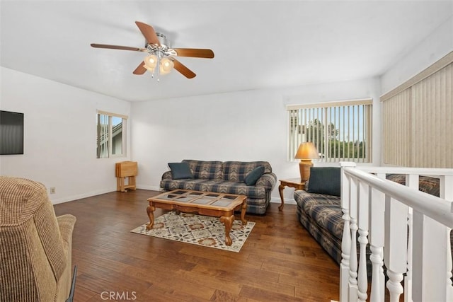 living room with dark wood-type flooring and ceiling fan