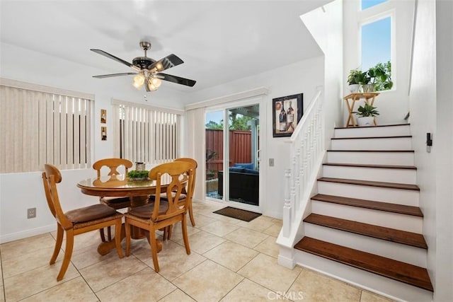 tiled dining space featuring ceiling fan