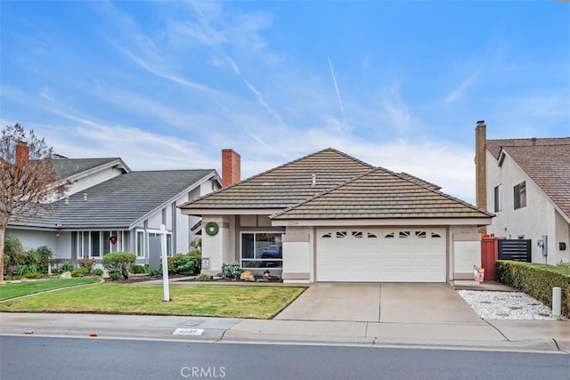 ranch-style house featuring a garage and a front yard