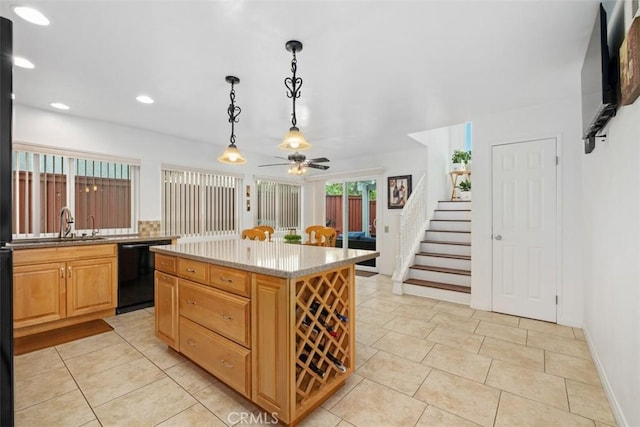 kitchen featuring pendant lighting, light tile patterned floors, dishwasher, light stone countertops, and a kitchen island