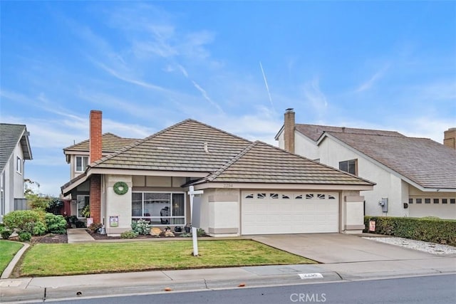 view of front of home with a garage and a front yard