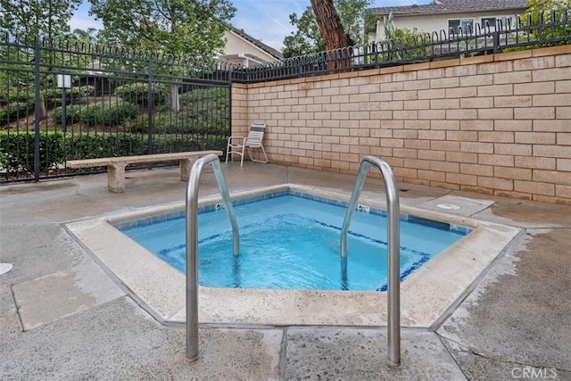 view of swimming pool featuring a community hot tub