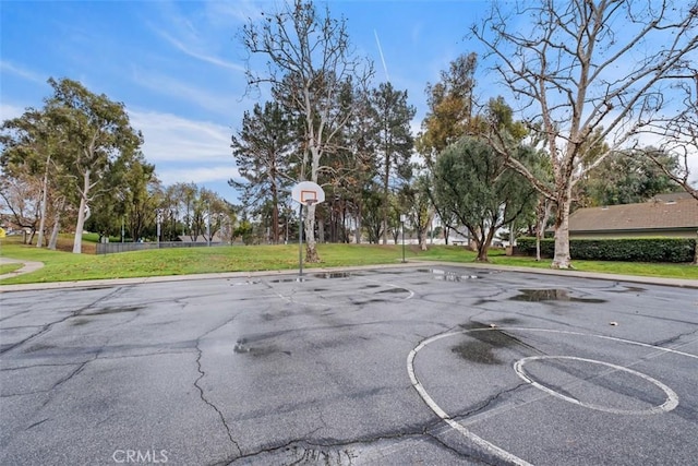 view of sport court featuring a yard