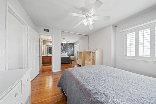 bedroom with wood-type flooring, ceiling fan, and a closet