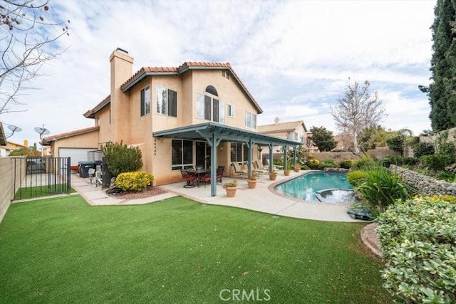 back of property featuring a fenced in pool, a patio, and a lawn