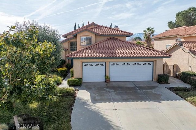 mediterranean / spanish house with a garage