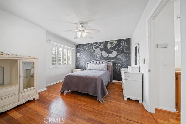 bedroom featuring hardwood / wood-style flooring and ceiling fan