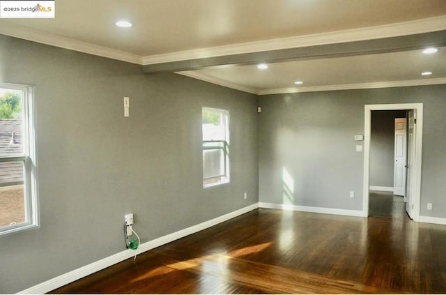 spare room with ornamental molding and dark hardwood / wood-style floors