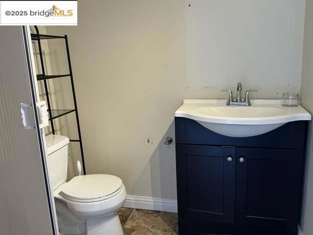 bathroom with vanity, tile patterned flooring, and toilet