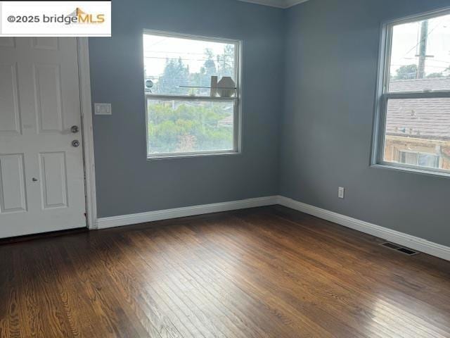 empty room featuring dark wood-type flooring