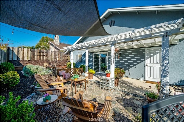 view of patio / terrace with fence and a pergola