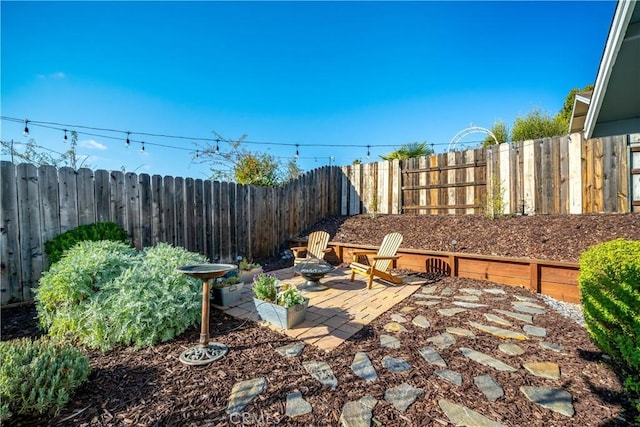 view of patio with an outdoor fire pit and a fenced backyard