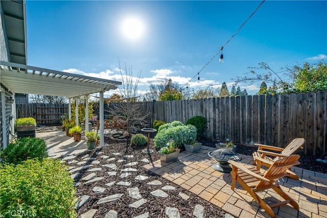 view of patio with an outdoor fire pit, a fenced backyard, and a pergola