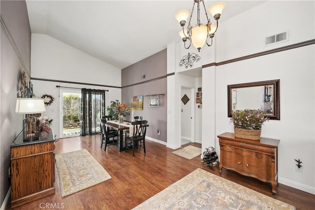 dining area featuring baseboards, wood finished floors, visible vents, and an inviting chandelier