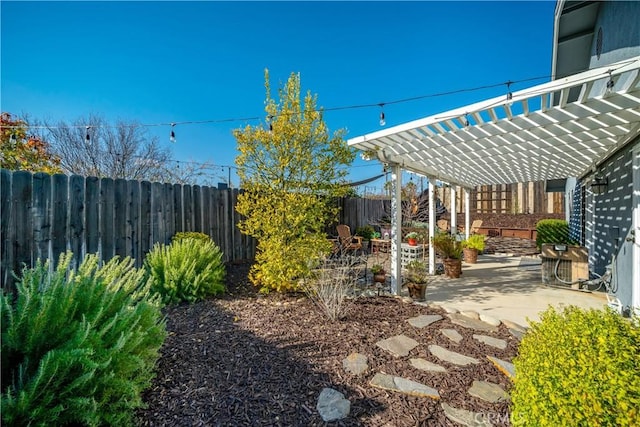 view of yard featuring a patio, a fenced backyard, and a pergola